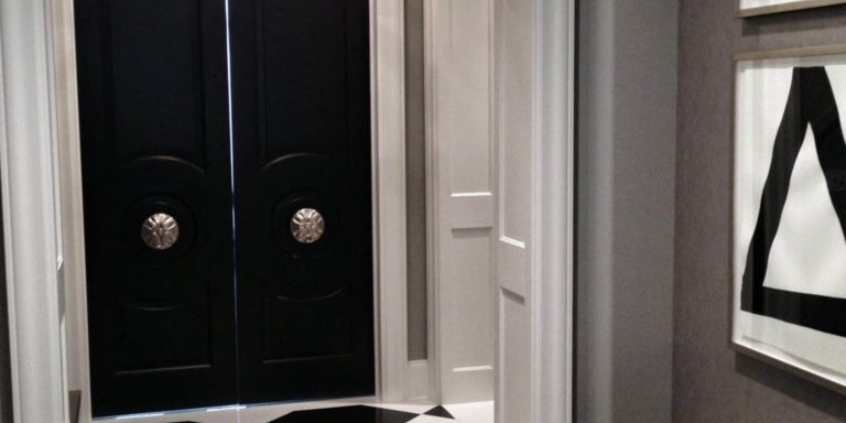 Luxury entryway with black doors