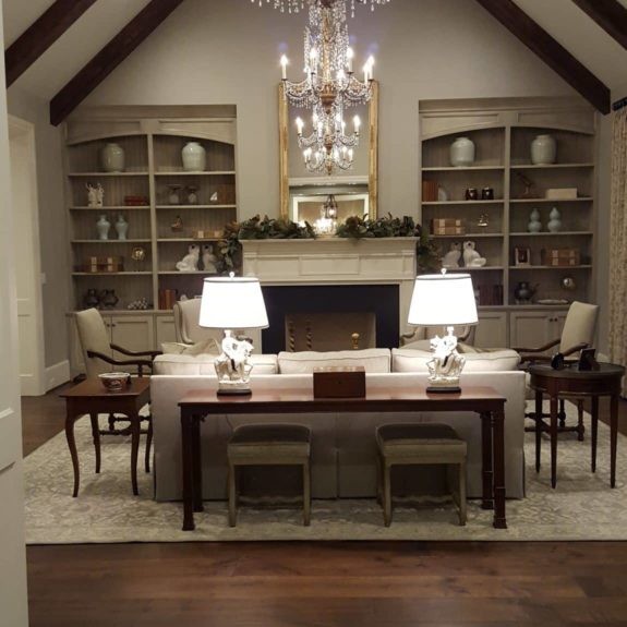 Living room interior design with white stone fireplace and crystal chandelier