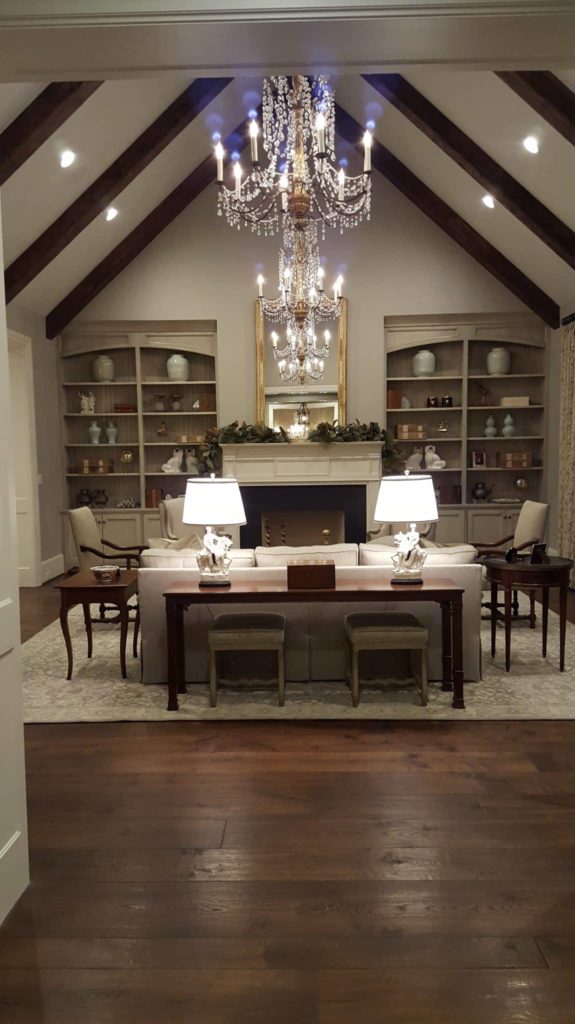 Living room interior design with white stone fireplace and crystal chandelier