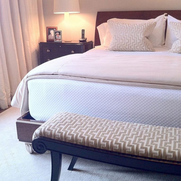 White bedroom interior design with ottoman