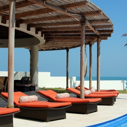 Pool area with bright orange lounge chairs