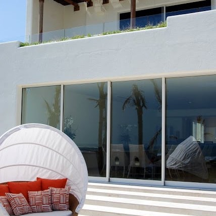 Outdoor patio design with white and red wicker chair