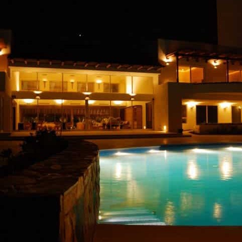 In-ground pool area design at night