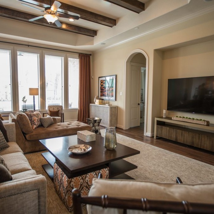 Beige and orange living room design with flatscreen TV