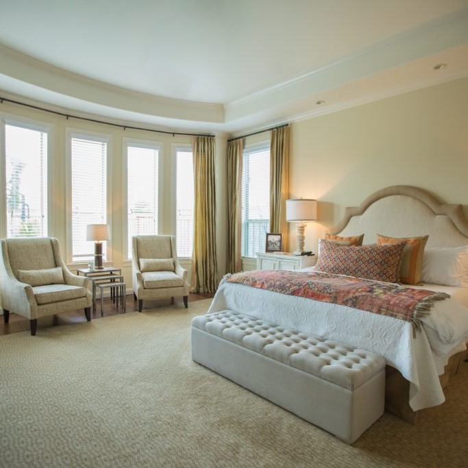 White bedroom design with red and orange bedding