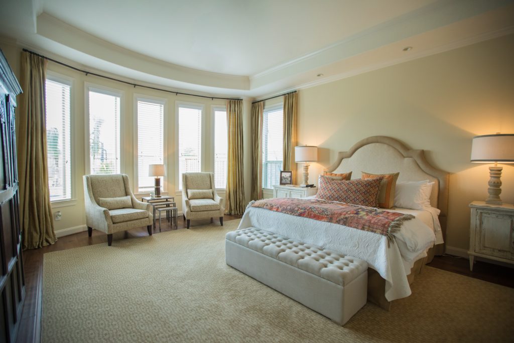 White bedroom design with red and orange bedding