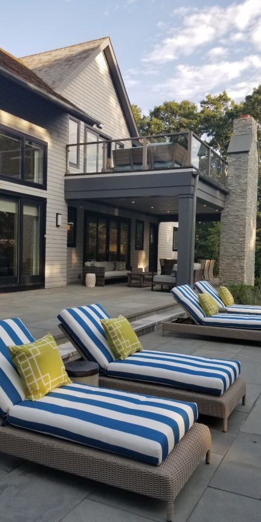 Blue and white striped lounge chairs as part of a patio design