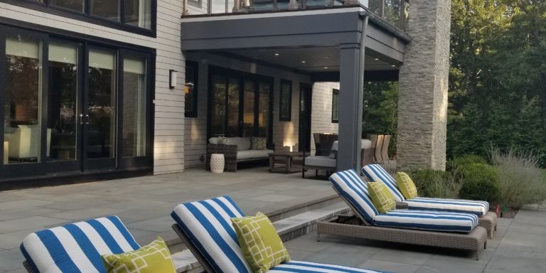 Blue and white striped lounge chairs as part of a patio design