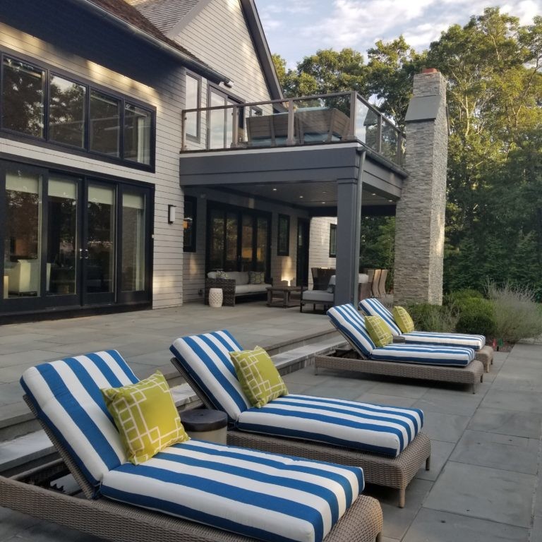 Blue and white striped lounge chairs as part of a patio design