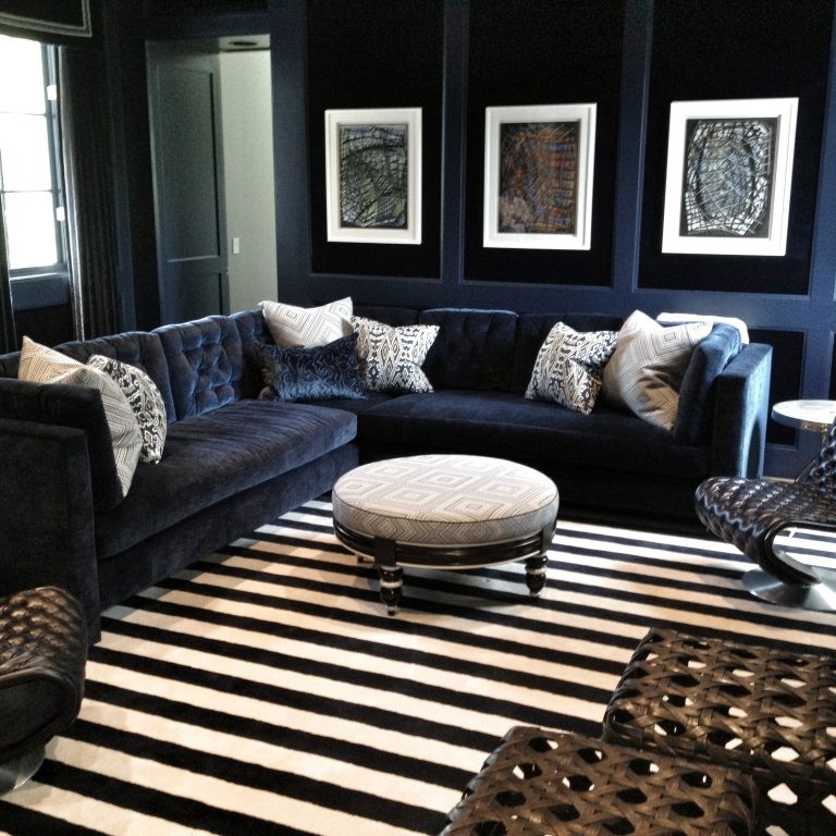 Elegant media room design with a velvet sofa and unique chairs