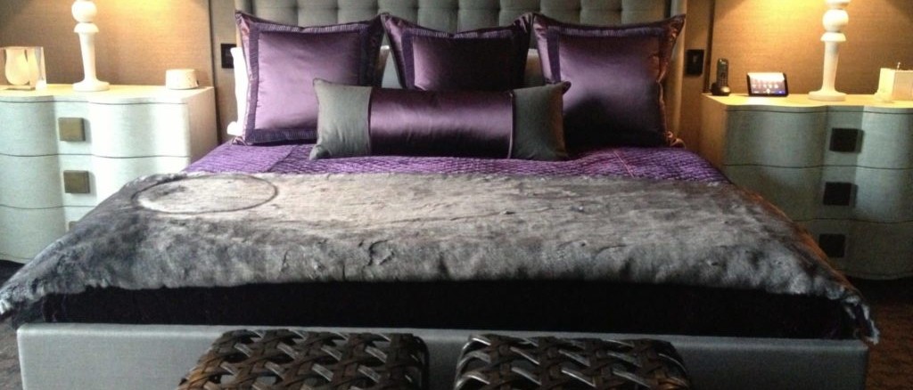Gray and purple bedding with satin and faux fur textures