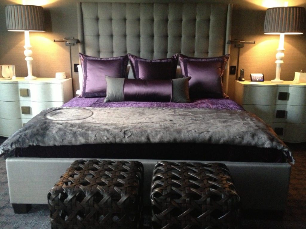 Gray and purple bedding with satin and faux fur textures