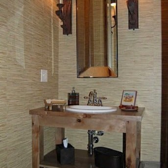 Rustic bathroom sink with long mirror and wall lights