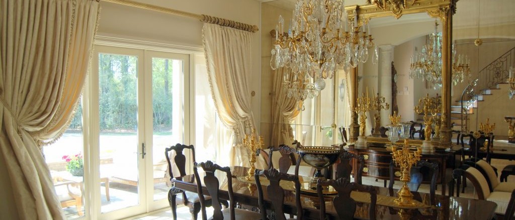 Elegant dining room design with dark woods, gold, and white tones