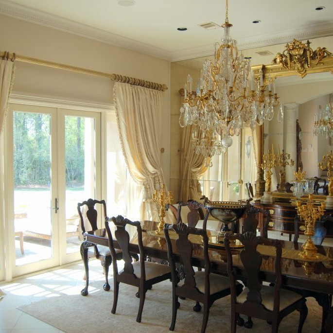 Elegant dining room design with dark woods, gold, and white tones