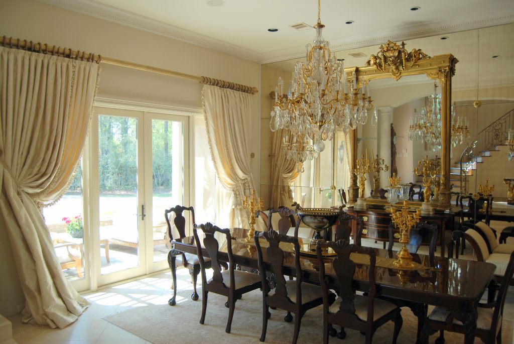 Elegant dining room design with dark woods, gold, and white tones