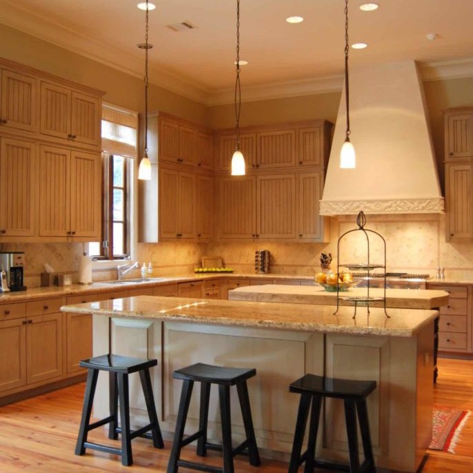 Kitchen interior design with hanging pendant lights above a marble island