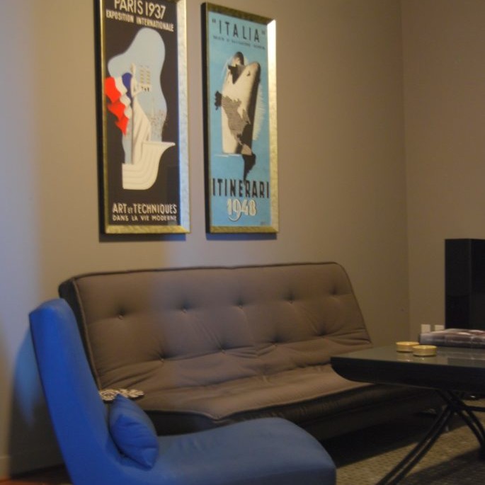 Bedroom interior design with gray futon and blue chair