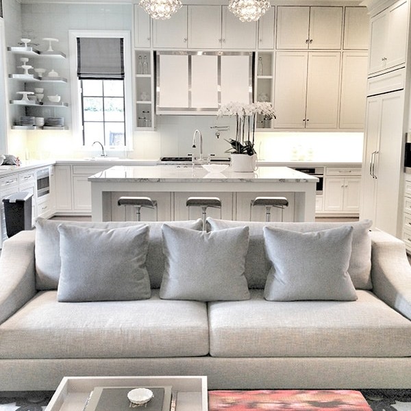 Gray and white living room and kitchen design with red accents