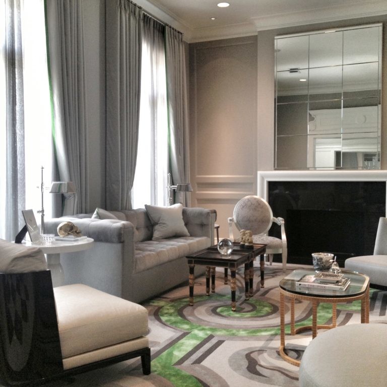 Silver-toned living room design with green accent rug