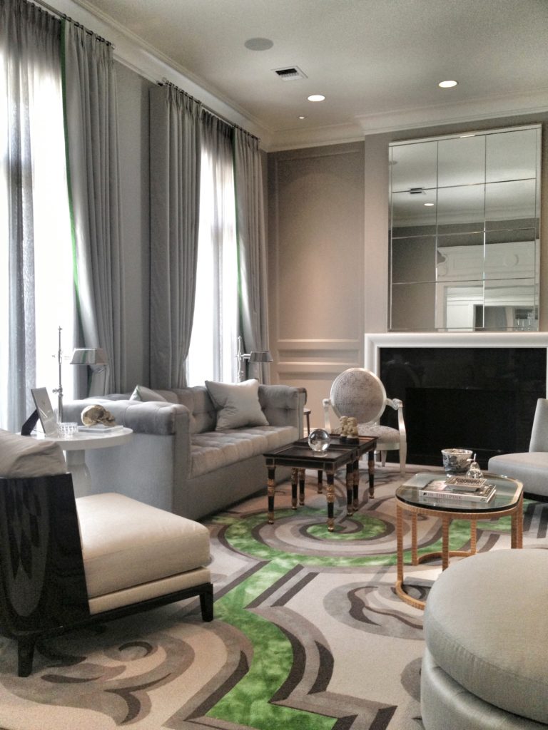 Silver-toned living room design with green accent rug
