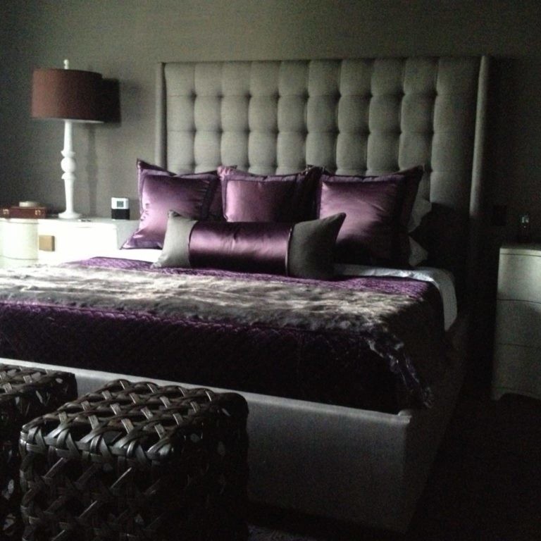 Dark gray and black bedroom design with purple silk accents