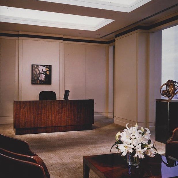 Executive office interior design with dark wood furniture