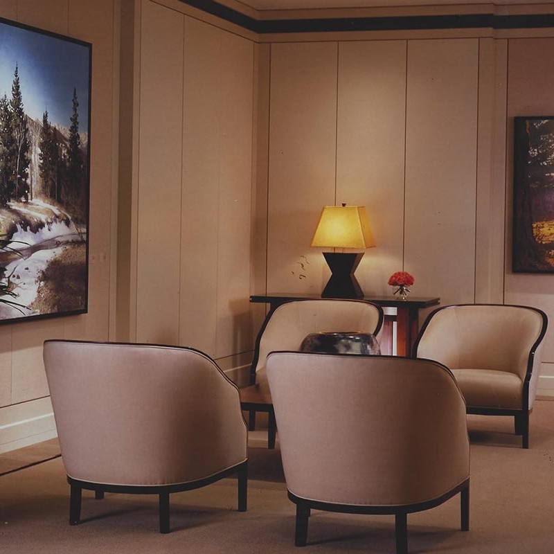 Beige waiting area interior design with large landscape paintings
