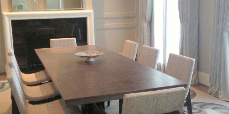 Silver-toned dining room interior design with a crystal chandelier