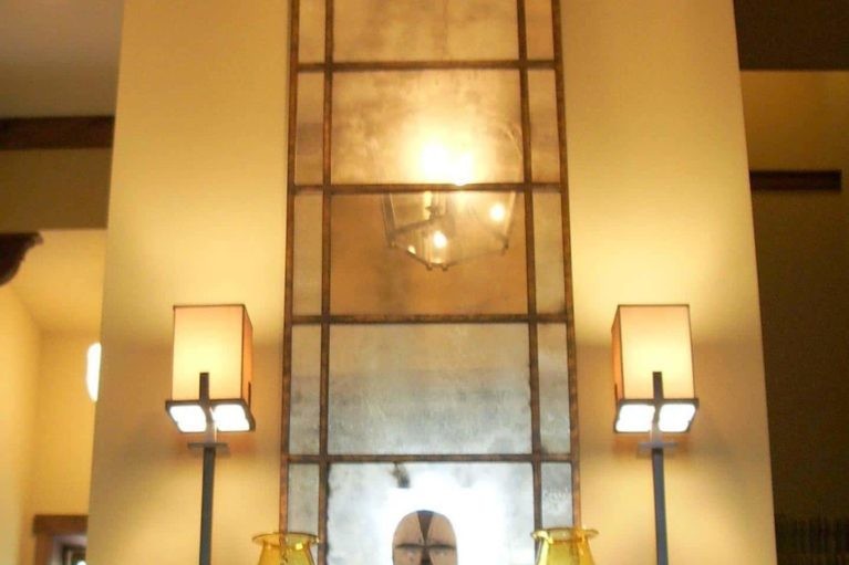 Large mirror above a dresser as part of a lake house's interior design