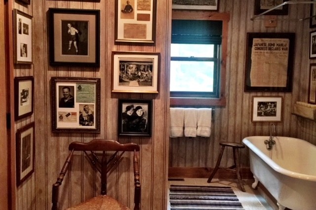 Rustic bathroom interior design with a lot of pictures hanging on the wall