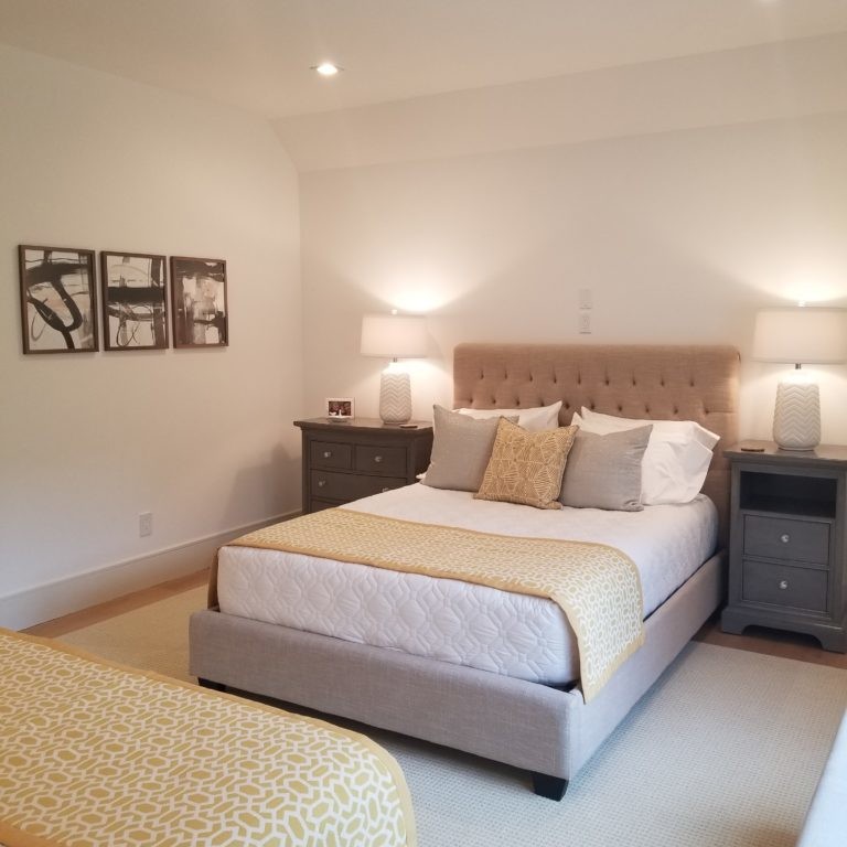 Yellow and cream bedroom interior design in Hamptons, NY