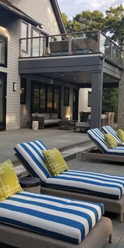 Blue and white striped lounge chairs as part of a patio design in Hamptons, NY