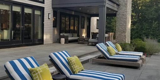 Blue and white striped lounge chairs as part of a patio design in Hamptons, NY