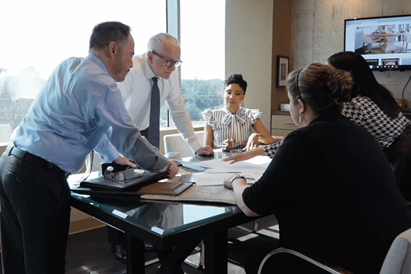 Group of businesspeople having a discussion around a conference table