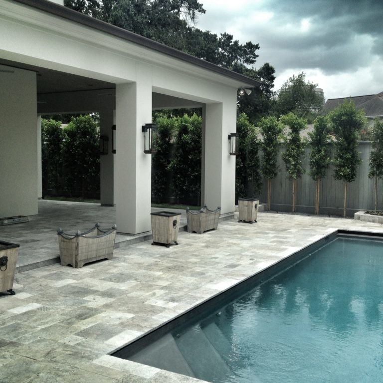 Exterior design of a gray-toned patio with an in-ground pool