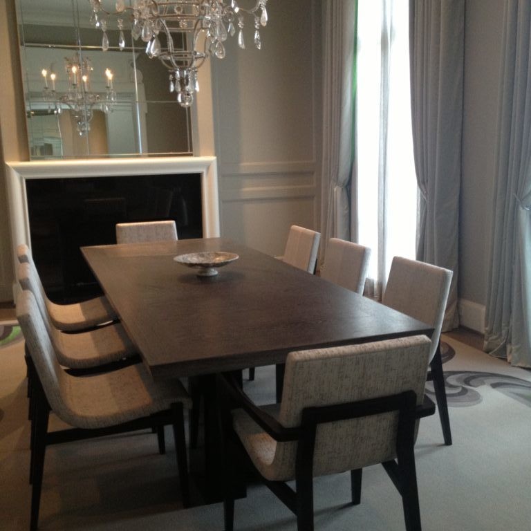 Silver-toned dining room interior design with a crystal chandelier