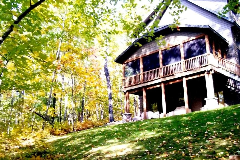 The rear exterior of a lake house in Northwoods, Wisconsin